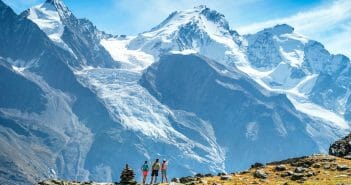 The Via Valais Trail runners in the landscape looking at the Dom, while on the Via Valais, a multi-day trail running tour connecting Verbier with Zermatt, Switzerland.